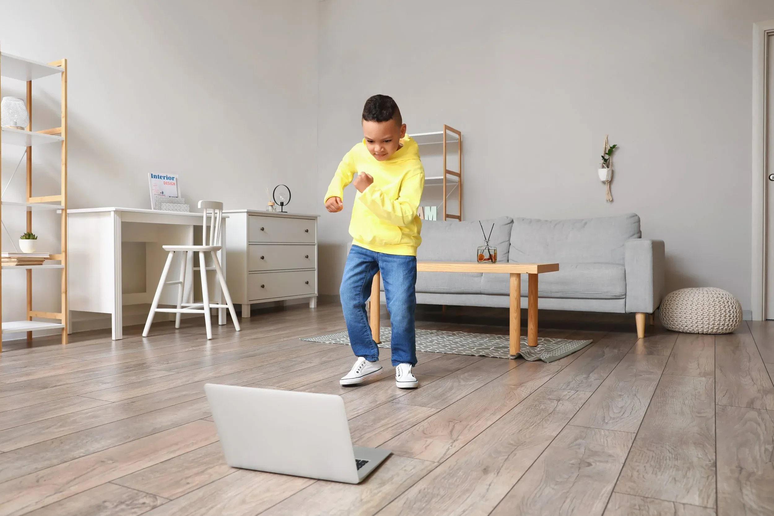 A boy learning hip hop from a laptop at home